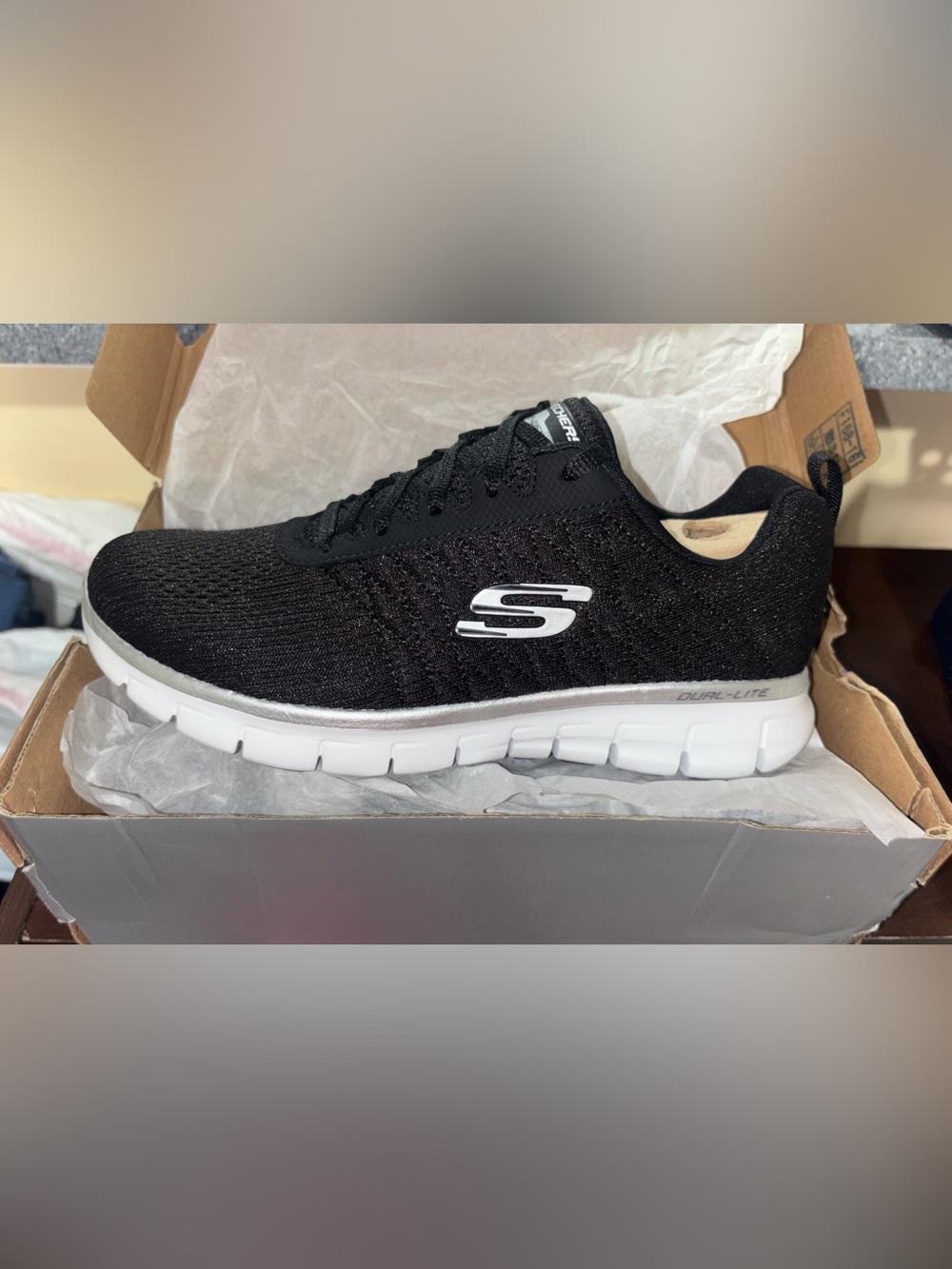 Skechers Woman’s Black Knit Slip-On Sneaker with White Sole